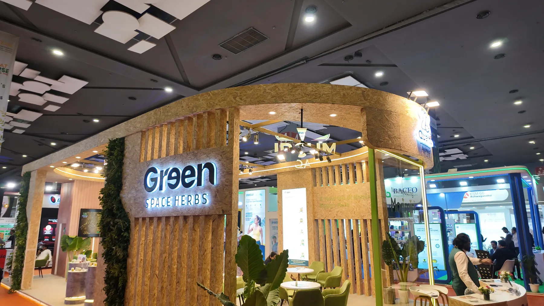 The front of the Greenspace Herbs booth at Bharat Nutraverse 2026 under the lit Greenspace Herbs sign