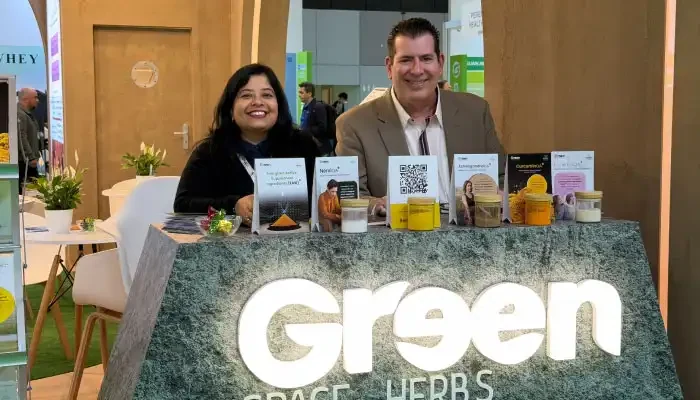 Two members of the team behind the lit Greenspace Herbs counter at Vitafoods Europe 2026
