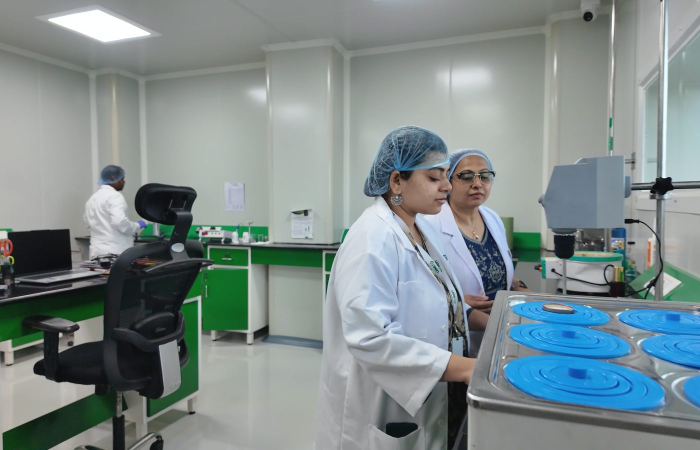 Scientists at work in the Vignanaveda lab, a water bath in the foreground