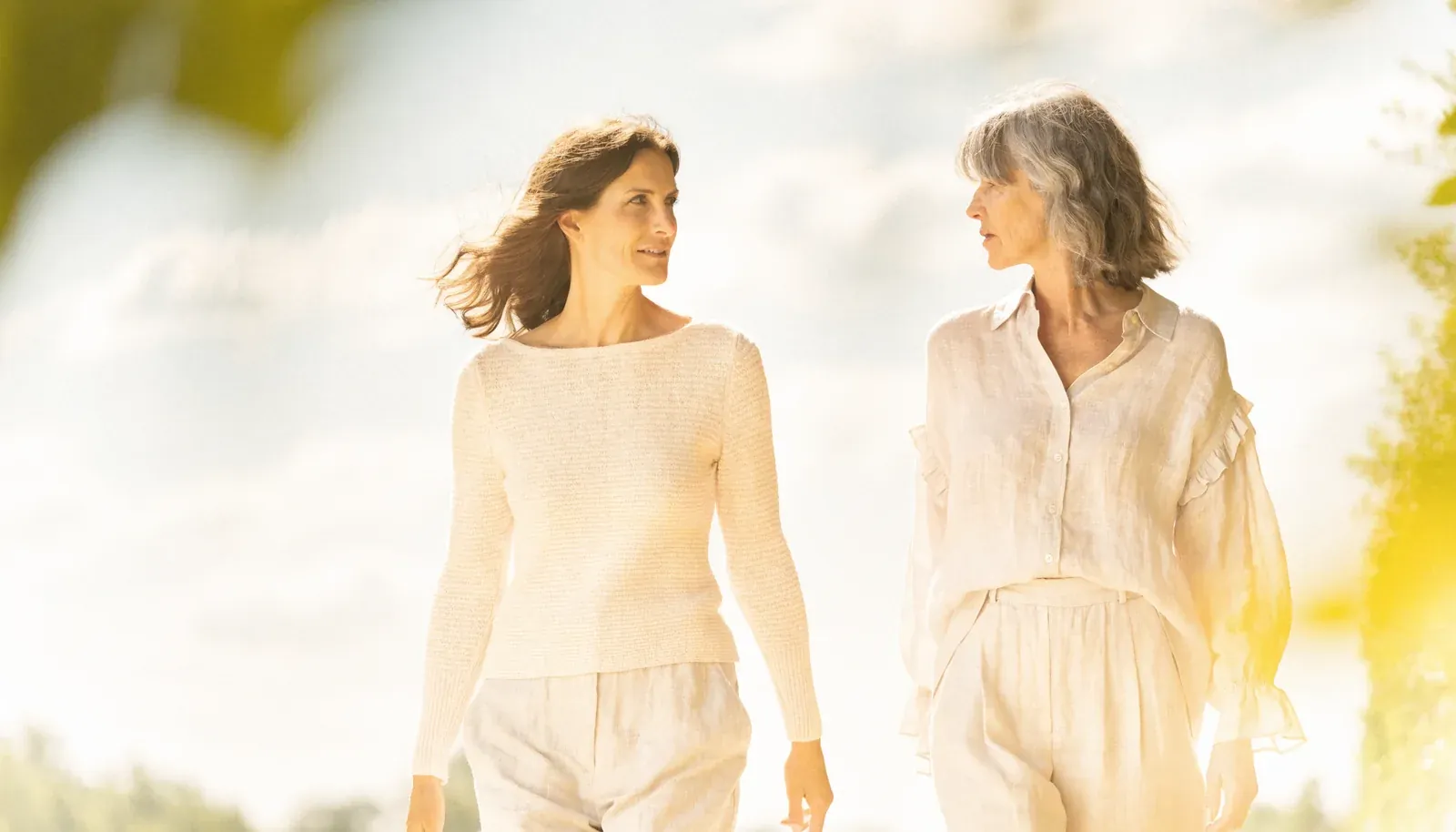 Two women walking together in soft morning light