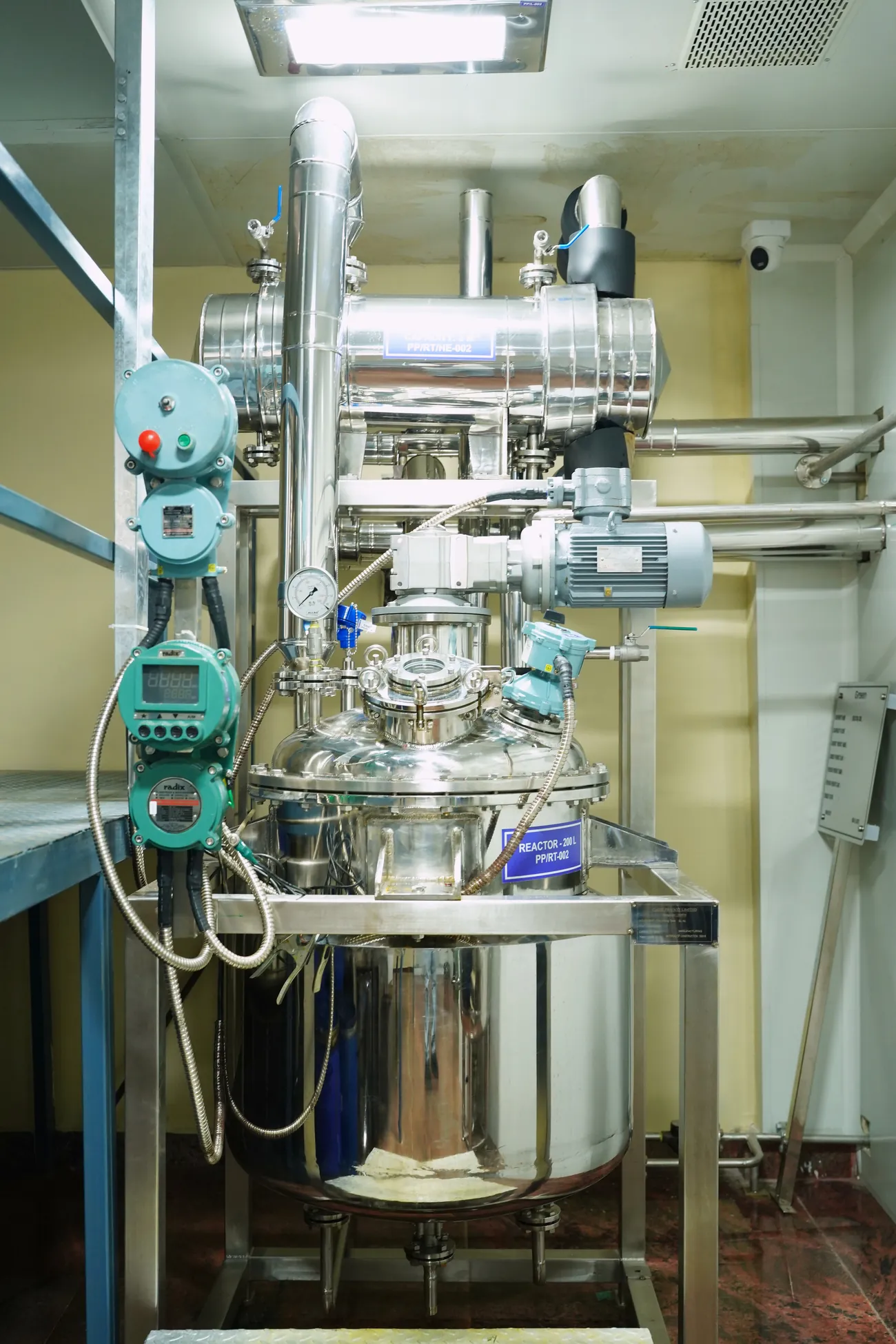 A 200-litre stainless reactor in the pilot plant, with its condenser, control panels and gauges