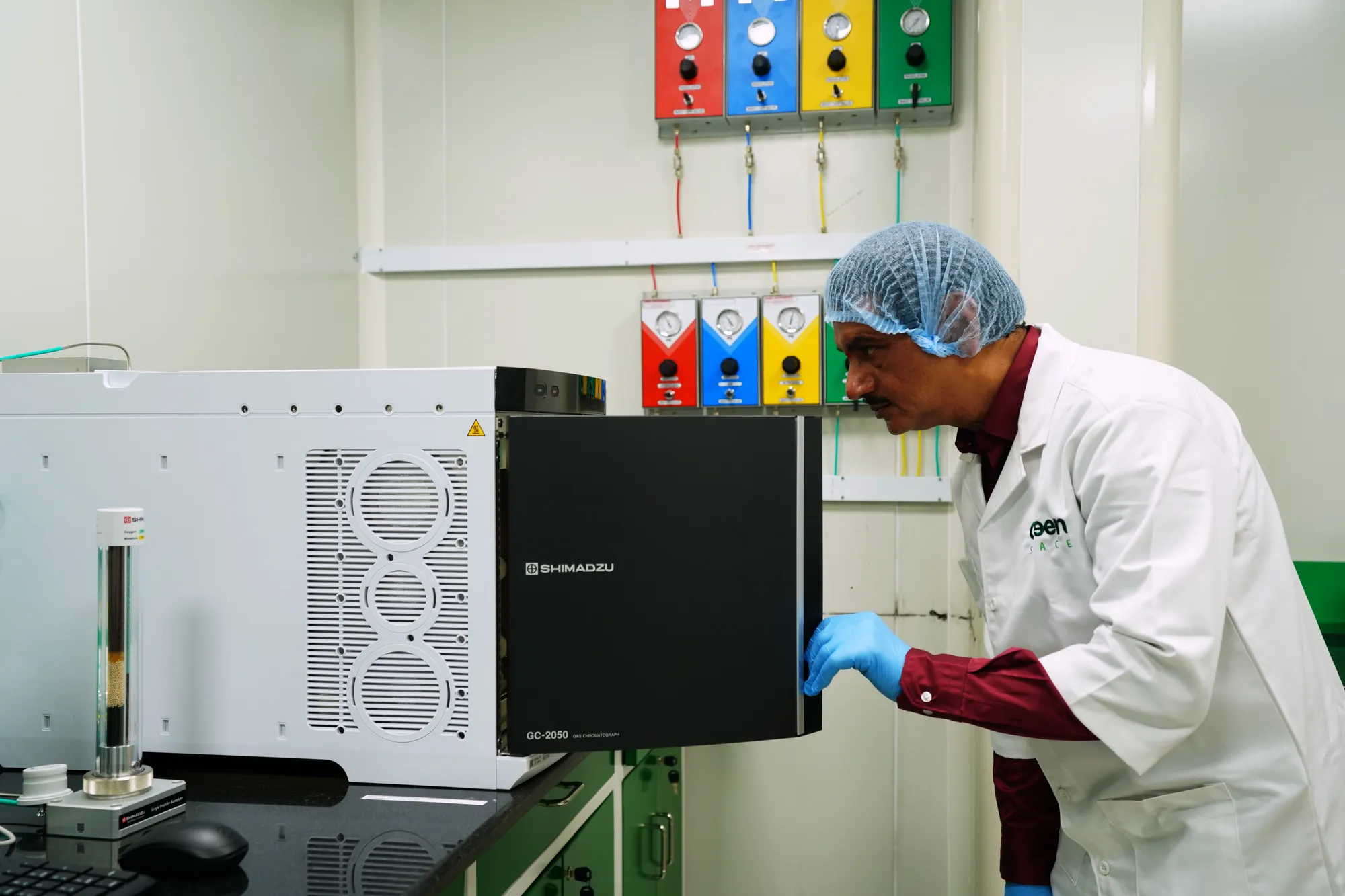 An analyst opening the oven of the gas chromatograph