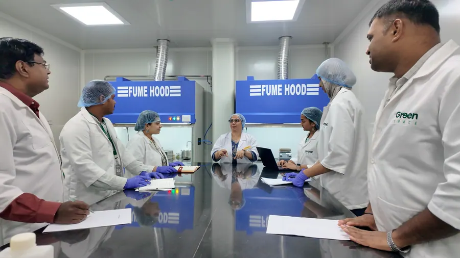 The Vignanaveda team discussing results at the fume hoods