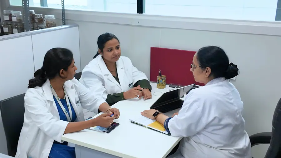Three scientists in a meeting