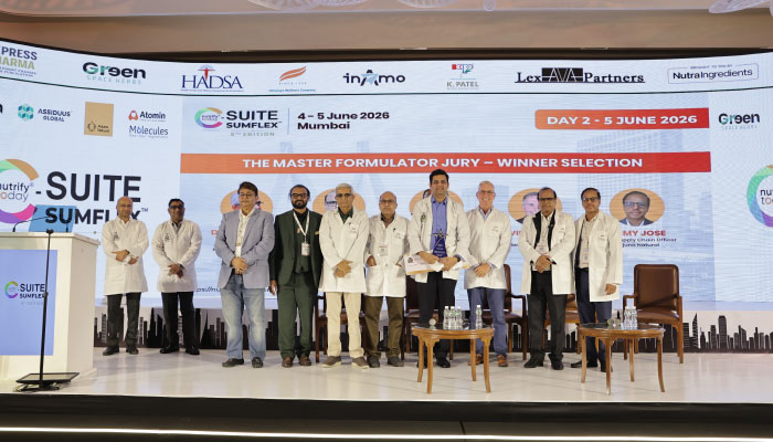 Group of presenters and jurors in white coats on a stage at a pharma conference, backdrop reads 'The Master Formulator Jury – Winner Selection' with sponsor logos.